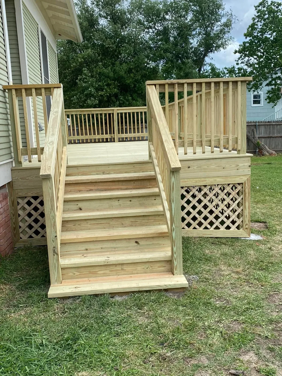 New wood deck stairs and railing on a raised deck in Bryan, Texas