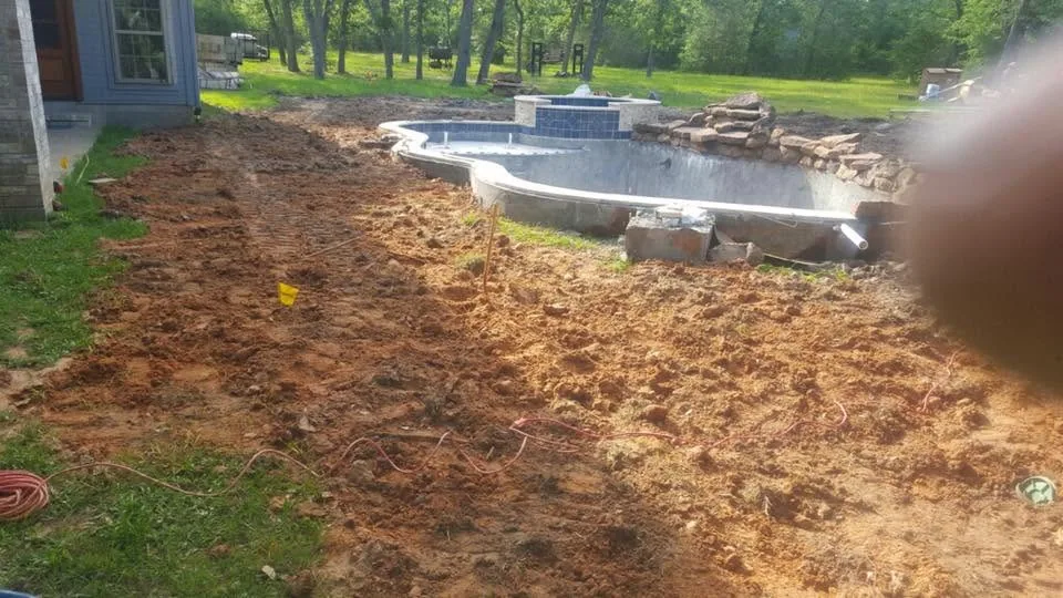 Backyard excavated and graded ahead of a pool and patio build in Bryan, Texas