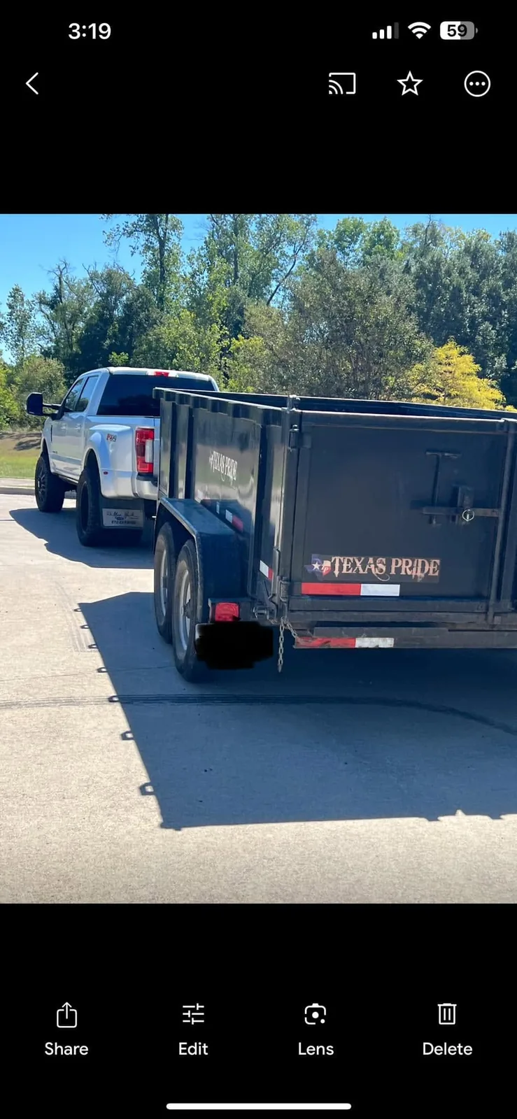 GreenRiver Landscaping truck and dump trailer on a job in Bryan, Texas